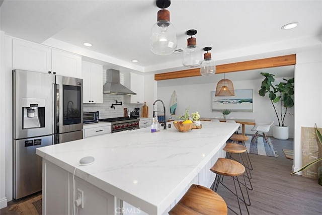 24132 Snipe Ln, Laguna Niguel, CA 92677 - kitchen featuring appliances with stainless steel finishes, wall chimney range hood, dark wood-style floors, recessed lighting, and white cabinets
