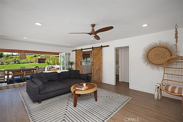 24132 Snipe Ln, Laguna Niguel, CA 92677 - living area featuring healthy amount of natural light, a barn door, wood finished floors, a ceiling fan, and recessed lighting
