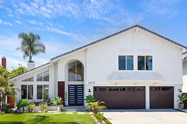 24132 Snipe Ln, Laguna Niguel, CA 92677 - view of front of property featuring an attached garage, a chimney, driveway, stucco siding, and a front yard
