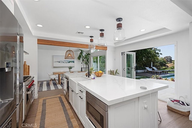 24132 Snipe Ln, Laguna Niguel, CA 92677 - kitchen featuring appliances with stainless steel finishes, recessed lighting, white cabinetry, dark wood-style flooring, and a raised ceiling