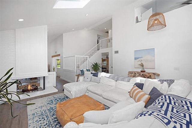 24132 Snipe Ln, Laguna Niguel, CA 92677 - living area featuring wood finished floors, high vaulted ceiling, a skylight, stairway, and recessed lighting