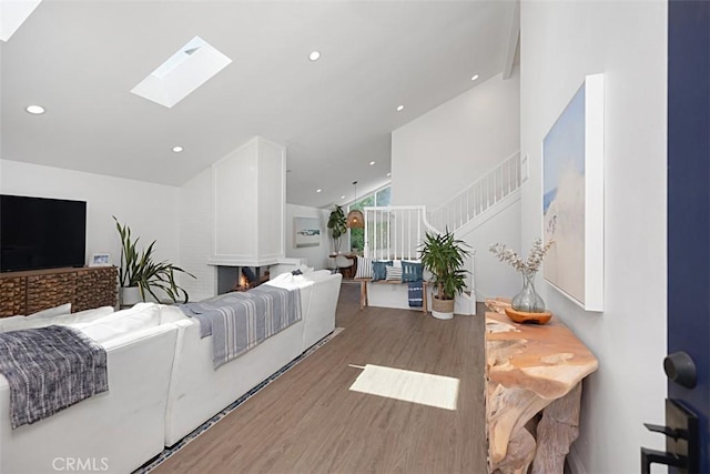 24132 Snipe Ln, Laguna Niguel, CA 92677 - living room with wood finished floors, stairs, a skylight, recessed lighting, and high vaulted ceiling