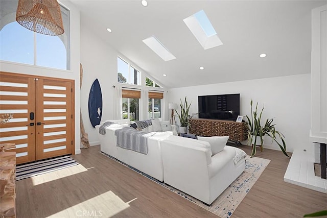 24132 Snipe Ln, Laguna Niguel, CA 92677 - living area with high vaulted ceiling, a skylight, recessed lighting, wood finished floors, and baseboards