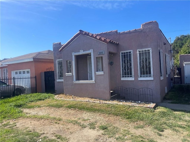 3641 E Elizabeth St, Compton, CA 90221 - view of front of home with a garage and stucco siding