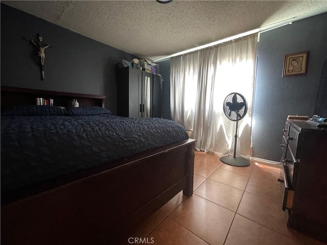 3641 E Elizabeth St, Compton, CA 90221 - tiled bedroom featuring a textured ceiling