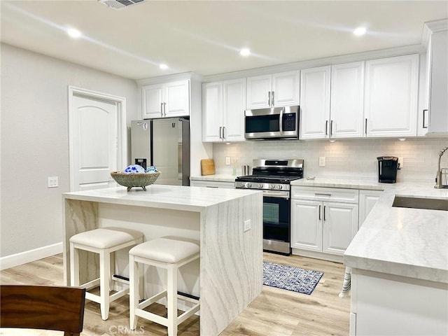 24082 Calendula, Mission Viejo, CA 92692 - kitchen featuring appliances with stainless steel finishes, a sink, backsplash, and light wood-type flooring