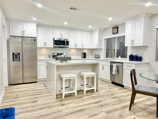 24082 Calendula, Mission Viejo, CA 92692 - kitchen featuring stainless steel appliances, white cabinets, a kitchen island, a sink, and recessed lighting