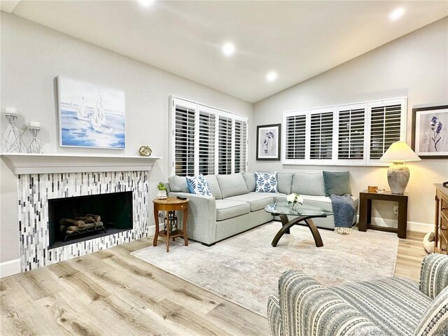 24082 Calendula, Mission Viejo, CA 92692 - living area featuring lofted ceiling, wood finished floors, recessed lighting, a brick fireplace, and baseboards
