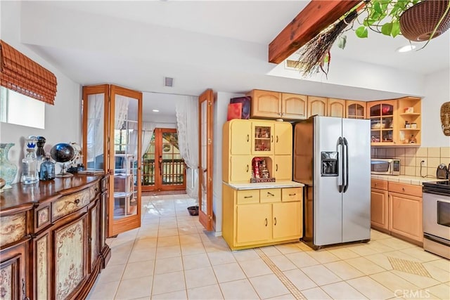 kitchen with stainless steel appliances, french doors, light tile patterned floors, tile counters, and recessed lighting