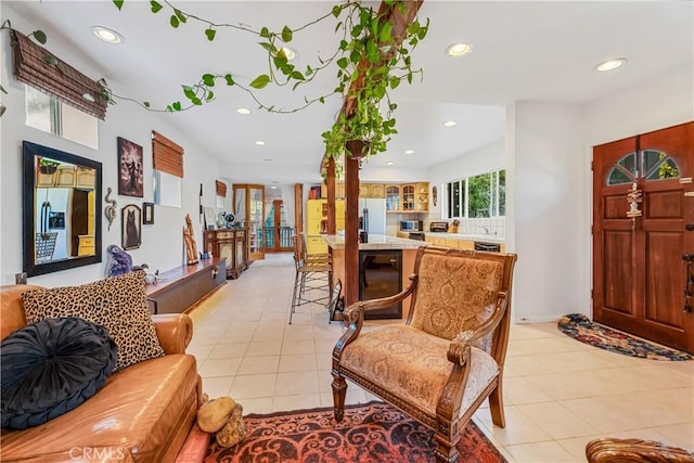 foyer with recessed lighting, light tile patterned flooring, and beverage cooler