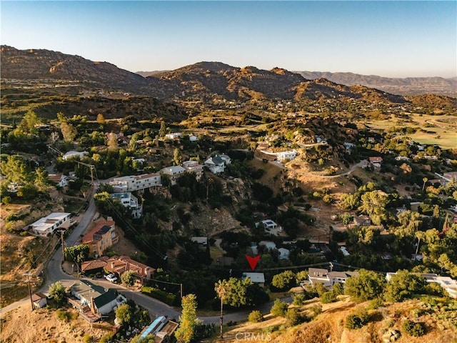 aerial view of property and surrounding area featuring mountains
