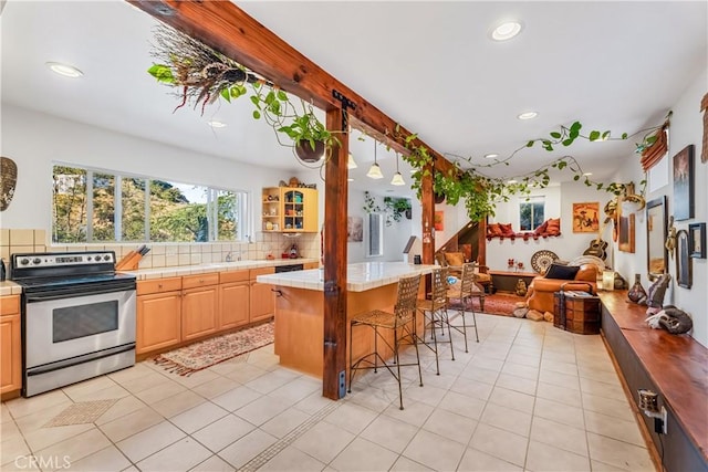 kitchen with stainless steel range with electric cooktop, tile counters, backsplash, open floor plan, and recessed lighting