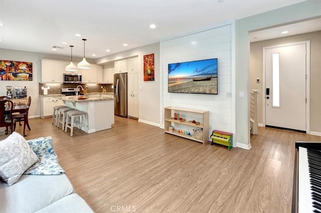 10561 Cannon Dr, Rancho Cucamonga, CA 91730 - living area featuring light wood-type flooring, recessed lighting, and baseboards