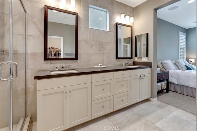 10561 Cannon Dr, Rancho Cucamonga, CA 91730 - full bathroom featuring tile walls, a shower stall, healthy amount of natural light, and double vanity