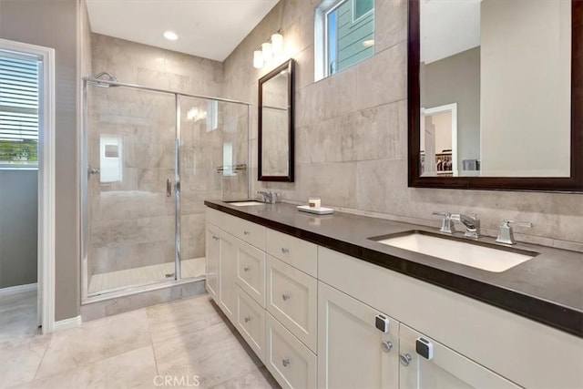 10561 Cannon Dr, Rancho Cucamonga, CA 91730 - full bath featuring a shower stall, double vanity, tile patterned floors, and tile walls