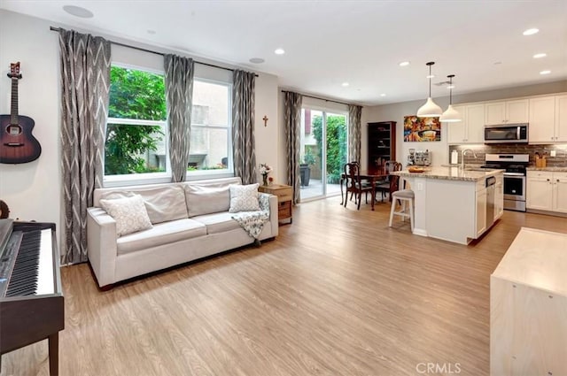 10561 Cannon Dr, Rancho Cucamonga, CA 91730 - living room featuring light wood finished floors and recessed lighting