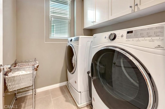 10561 Cannon Dr, Rancho Cucamonga, CA 91730 - laundry room with washer and clothes dryer, cabinet space, light tile patterned floors, and baseboards