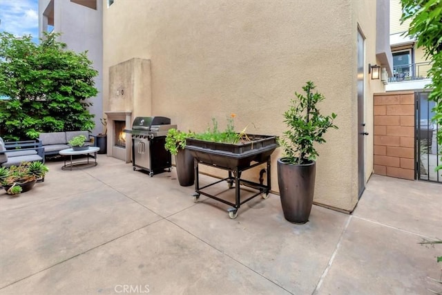 10561 Cannon Dr, Rancho Cucamonga, CA 91730 - view of patio with area for grilling and an outdoor living space with a fireplace