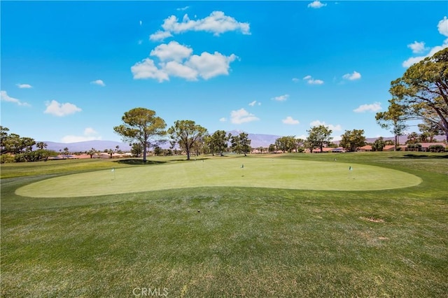 9653 Spyglass Ave Unit 99, Desert Hot Springs, CA 92240 - surrounding community with an area to practice putting, a mountain view, golf course view, and a yard