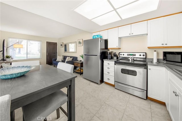 9653 Spyglass Ave Unit 99, Desert Hot Springs, CA 92240 - kitchen with appliances with stainless steel finishes, open floor plan, white cabinets, and dark countertops