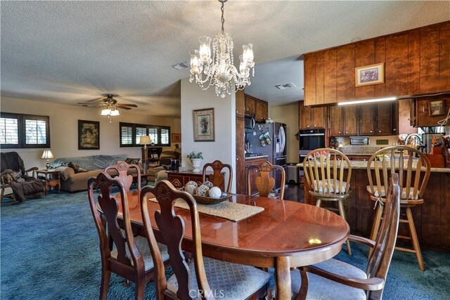 22972 Valley View Dr, Crestline, CA 92325 - carpeted dining room featuring a ceiling fan, a textured ceiling, and a chandelier
