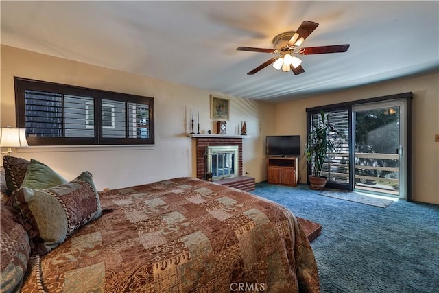22972 Valley View Dr, Crestline, CA 92325 - carpeted bedroom with a brick fireplace, access to exterior, and ceiling fan