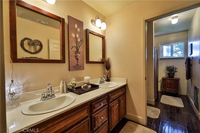 22972 Valley View Dr, Crestline, CA 92325 - full bath with wood finished floors, double vanity, and baseboards