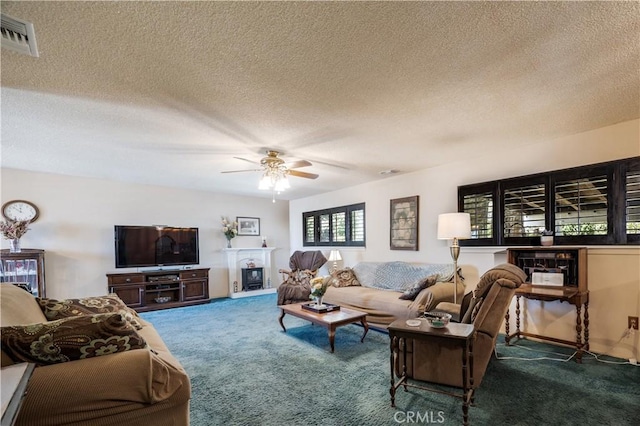 22972 Valley View Dr, Crestline, CA 92325 - living area with carpet, a textured ceiling, a ceiling fan, and a fireplace with raised hearth