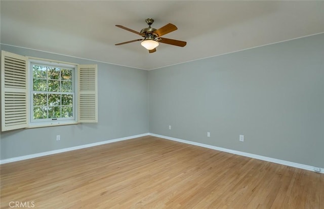 unfurnished room with baseboards, a ceiling fan, and light wood-type flooring