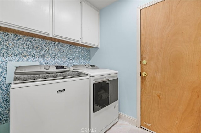 10213 Single Oak Dr, Bakersfield, CA 93311 - clothes washing area with washing machine and dryer, cabinet space, and baseboards