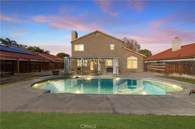 10213 Single Oak Dr, Bakersfield, CA 93311 - pool at dusk featuring a patio and a fenced backyard