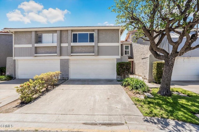 1314 Gina Dr, Oxnard, CA 93030 - view of front of property featuring driveway, stucco siding, and an attached garage