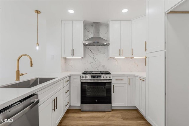 1314 Gina Dr, Oxnard, CA 93030 - kitchen featuring appliances with stainless steel finishes, wall chimney range hood, white cabinets, recessed lighting, and backsplash