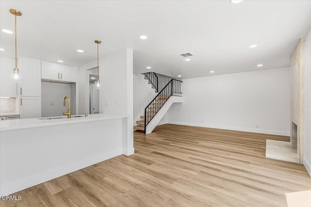 1314 Gina Dr, Oxnard, CA 93030 - unfurnished living room with light wood-style floors, stairs, and recessed lighting