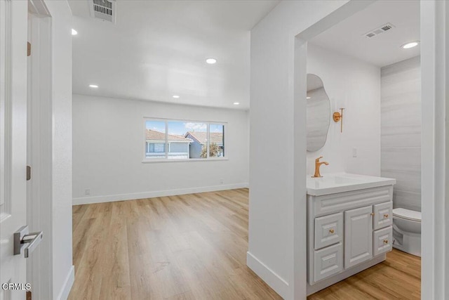 1314 Gina Dr, Oxnard, CA 93030 - bathroom featuring vanity, wood finished floors, and recessed lighting