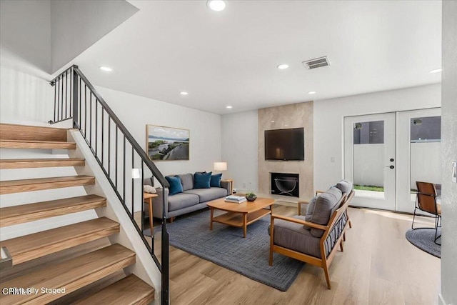 1314 Gina Dr, Oxnard, CA 93030 - living room featuring wood finished floors, a large fireplace, stairway, and recessed lighting