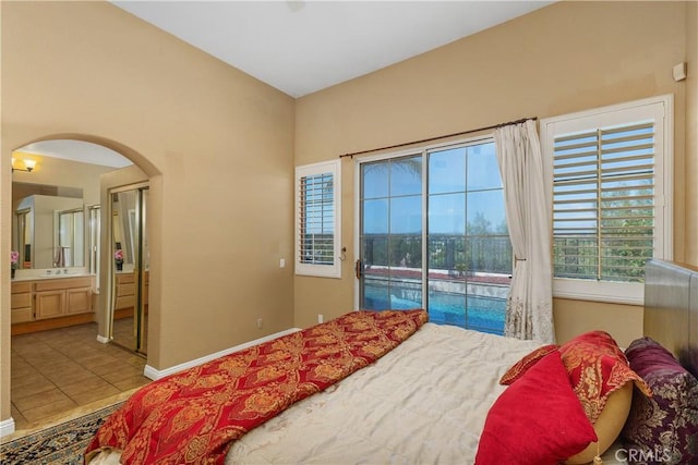 44886 Camino Veste, Temecula, CA 92592 - bedroom with access to exterior, arched walkways, tile patterned flooring, baseboards, and ensuite bath