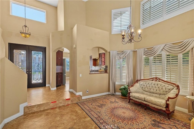 44886 Camino Veste, Temecula, CA 92592 - tiled foyer entrance featuring arched walkways, a towering ceiling, a chandelier, baseboards, and french doors