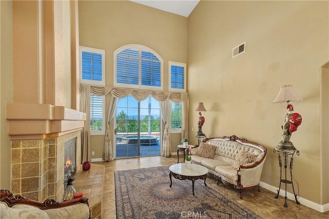 44886 Camino Veste, Temecula, CA 92592 - sitting room with a towering ceiling, baseboards, a tile fireplace, and tile patterned flooring