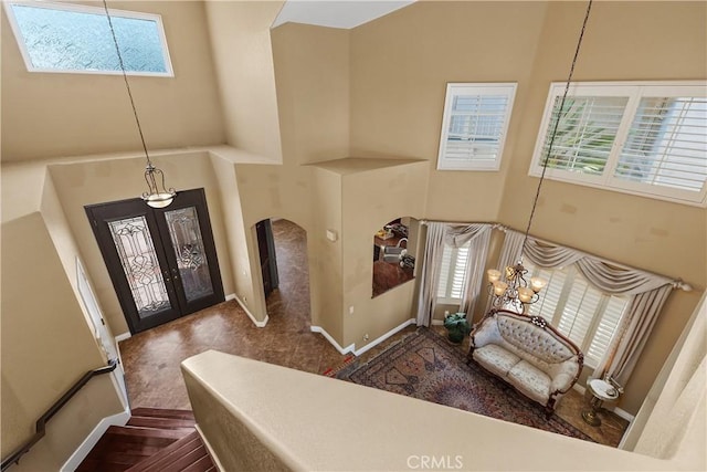 44886 Camino Veste, Temecula, CA 92592 - foyer entrance featuring a high ceiling, arched walkways, french doors, a chandelier, and baseboards