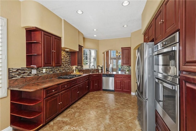 44886 Camino Veste, Temecula, CA 92592 - kitchen with open shelves, stainless steel appliances, reddish brown cabinets, tasteful backsplash, and recessed lighting