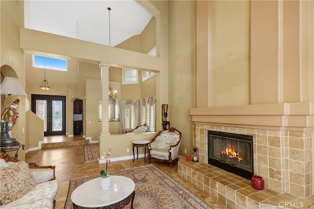 44886 Camino Veste, Temecula, CA 92592 - living room with a high ceiling, healthy amount of natural light, a tile fireplace, baseboards, and arched walkways