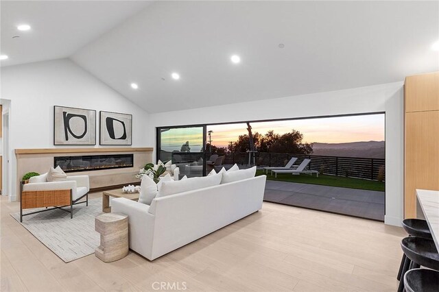 820 Calle Mendoza, San Clemente, CA 92672 - living area with high vaulted ceiling, light wood finished floors, recessed lighting, and a glass covered fireplace