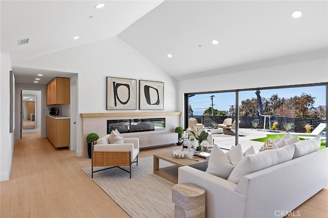 820 Calle Mendoza, San Clemente, CA 92672 - living room featuring recessed lighting, high vaulted ceiling, light wood-type flooring, and a glass covered fireplace
