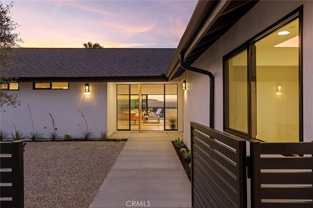 820 Calle Mendoza, San Clemente, CA 92672 - exterior entry at dusk with stucco siding and a shingled roof