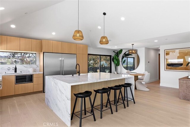 820 Calle Mendoza, San Clemente, CA 92672 - kitchen featuring built in appliances, modern cabinets, light wood-style floors, light stone countertops, and recessed lighting