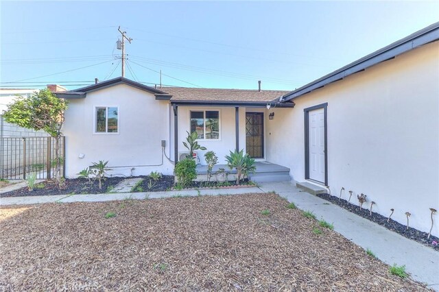 16928 Pocono St, La Puente, CA 91744 - view of front of house featuring stucco siding, covered porch, and a shingled roof