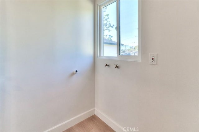 16928 Pocono St, La Puente, CA 91744 - laundry area featuring baseboards, hookup for a washing machine, light wood-type flooring, and hookup for an electric dryer