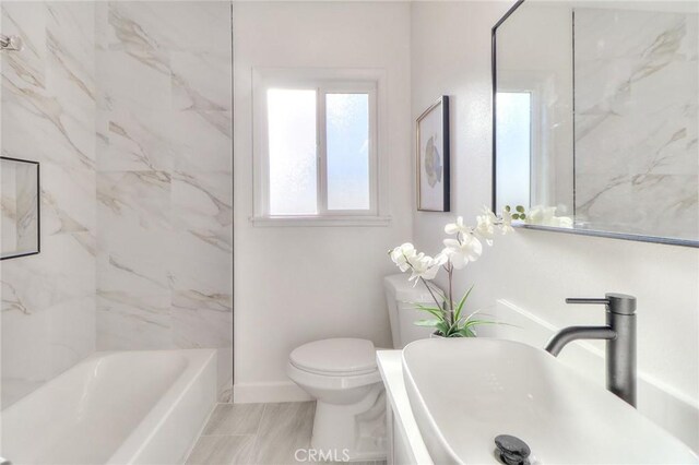 16928 Pocono St, La Puente, CA 91744 - bathroom featuring a sink, baseboards, and toilet