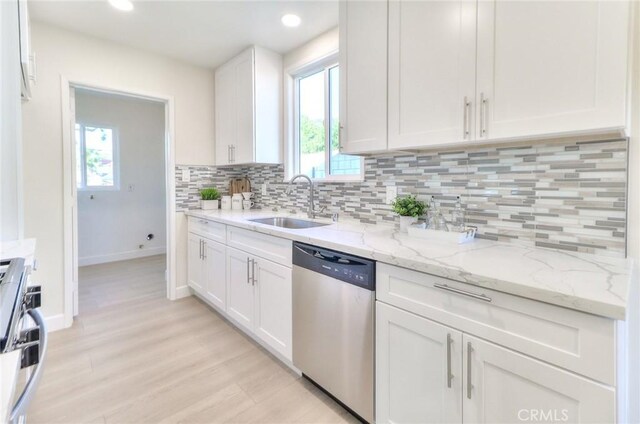 16928 Pocono St, La Puente, CA 91744 - kitchen featuring dishwasher, a sink, range, white cabinets, and backsplash